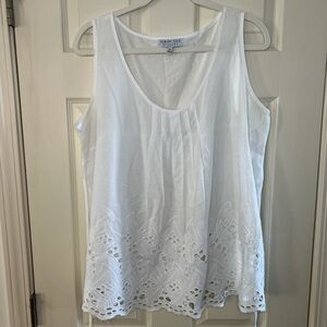 Flowy white top with eyelet detail at the bottom